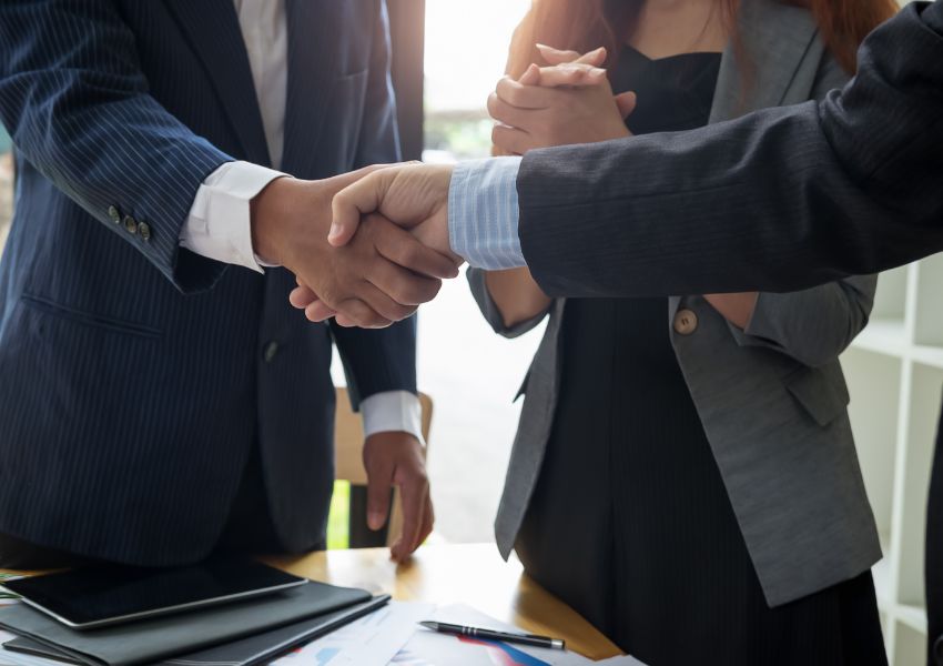 Property manager shaking hands with new tenant following a meeting